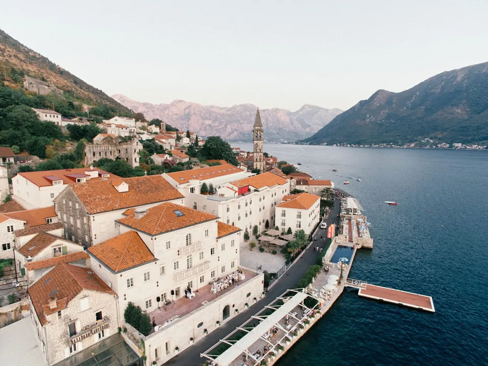Aerial view of Perast, hotel stone facades and the bay