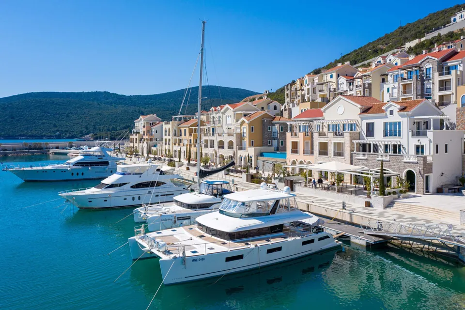 Motor yachts moored beside the village waterfront facades