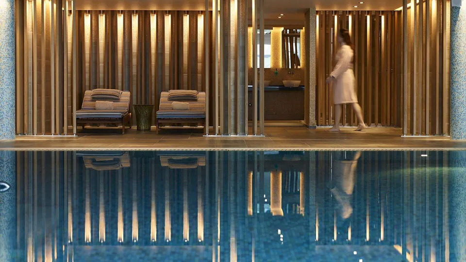 Indoor pool beneath a colonnade of light timber slats