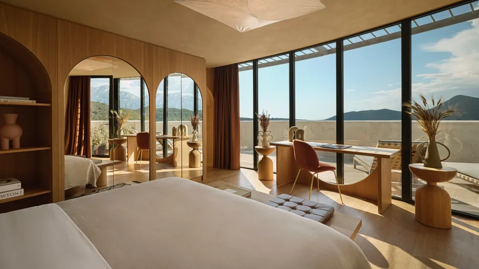 Panoramic suite with glass walls and terrace above Boka Bay