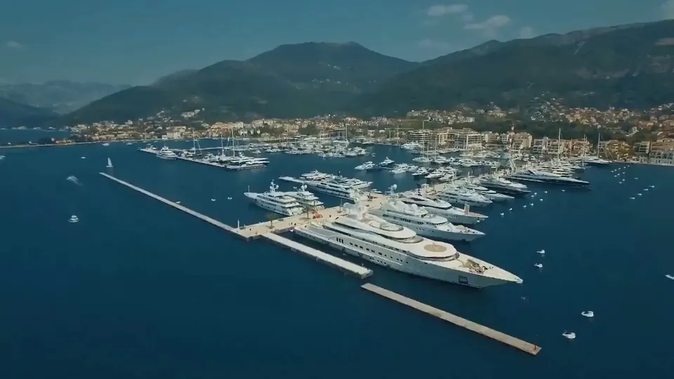 Porto Montenegro marina, superyacht at the quay and town beyond