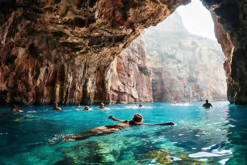 Swimmers inside Blue Cave lit by its entrance