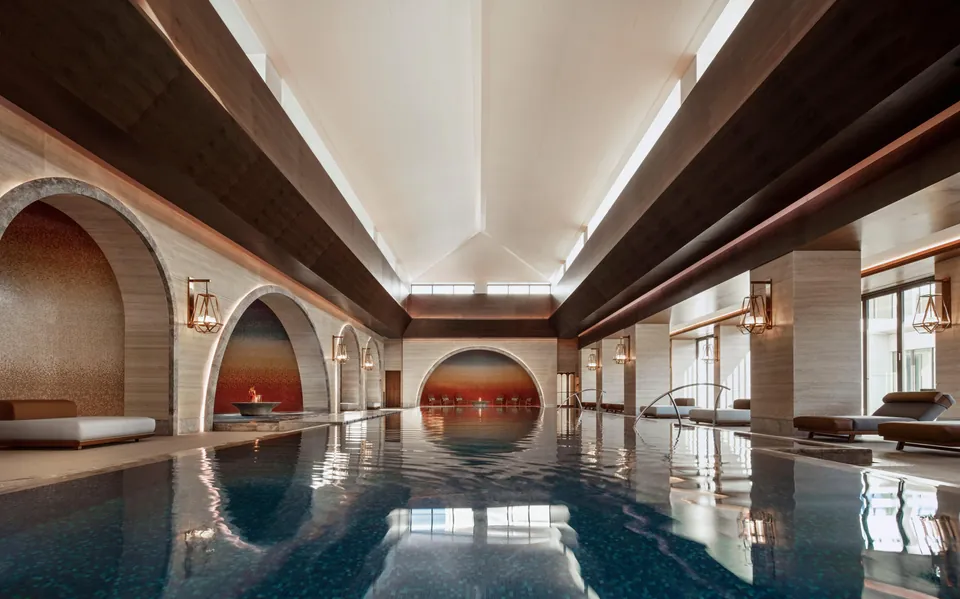 The indoor spa pool under mosaic arches at Chenot Espace