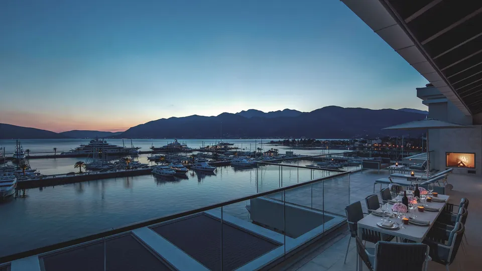The terrace at dusk above the marina, with the mountains of Boka Bay beyond