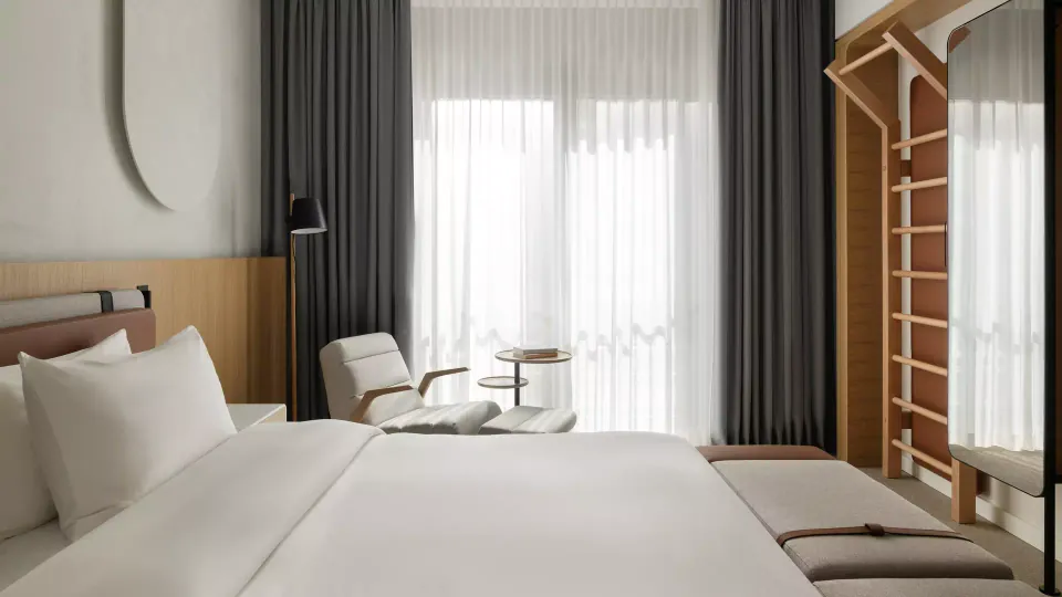 A guest room with wall bars built into the joinery beside the bed