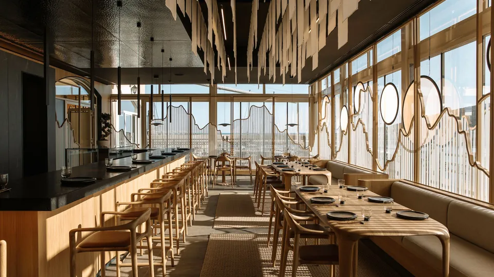 The restaurant interior in afternoon light, timber counter and oak chairs