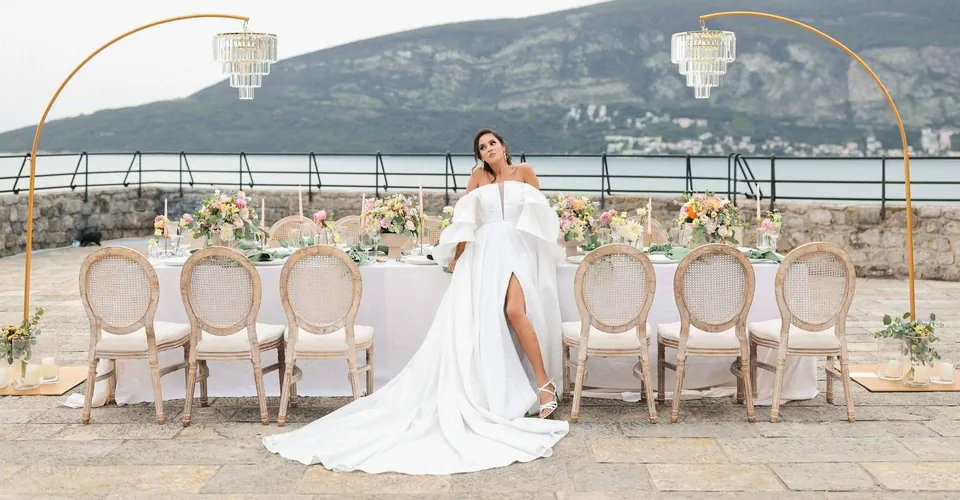Fortress terrace wedding table with gold arches and chandeliers